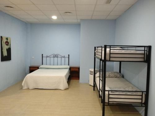 a bedroom with two bunk beds and a blue wall at Cádiz bahía in Cádiz