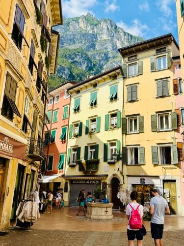 a group of people walking down a street with buildings at Casa Bors in Riva del Garda