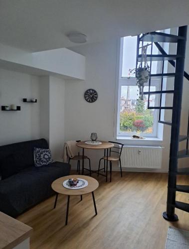 a living room with a couch and a table at ApartmánPohoda in Opava