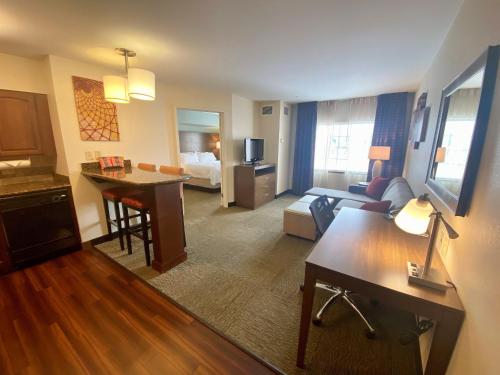 a living room with a room with a hotel room at Staybridge Suites Great Falls by IHG in Great Falls