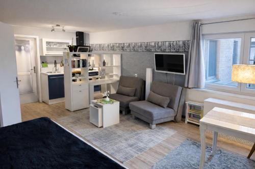 a living room with a couch and a chair at Wohnung mit Charme, Netflix in Rheinstetten
