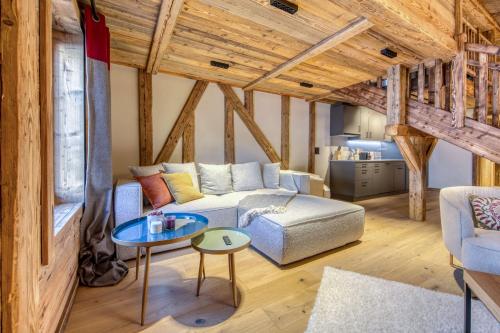 a living room with a couch and a table at Central High-End Duplexes, Sauna and Stove in Champéry