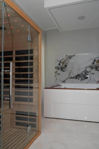 a glass shower in a room with a painting on the wall at SN Luxury Room & Spa in Foggia
