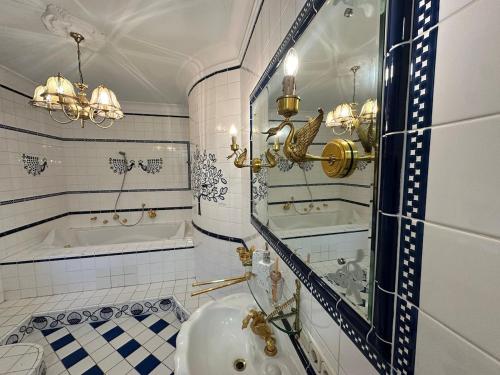 a bathroom with a tub and a sink and a mirror at City Honor Extravagance in Linz