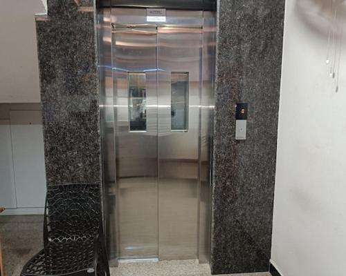 a elevator in a building with a glass door at Villa La Grande A Couple Friendly Property Near New Bus Stand in Pondicherry