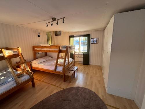 a room with two bunk beds and a hallway at Oleby Källbacken in Torsby