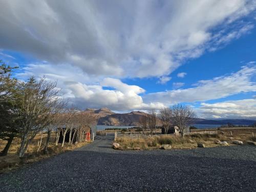 a road with a view of a lake and mountains at Little Loch View in Durnamuck