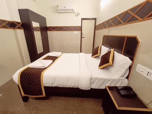 a bedroom with a large bed with white sheets and pillows at Villa La Grande A Couple Friendly Property Near New Bus Stand in Pondicherry