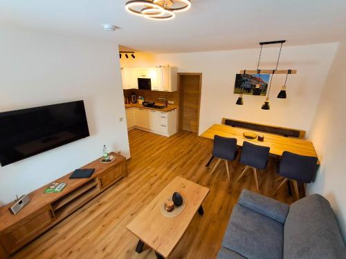 a living room with a couch and a table at Pension Kronenburghof in Erfurt