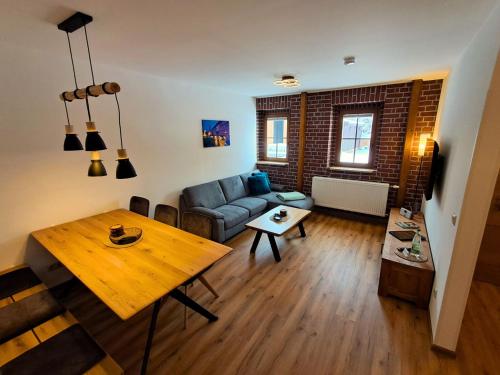 a living room with a couch and a table at Pension Kronenburghof in Erfurt