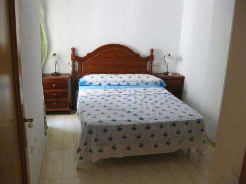 1 dormitorio con 1 cama con edredón azul en Apartment Manuel Galián 52, en Torrevieja