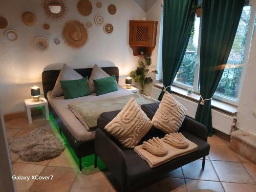 a living room with a couch and a chair at Green Oasis Stylish Garden Studio Workspace in Linz