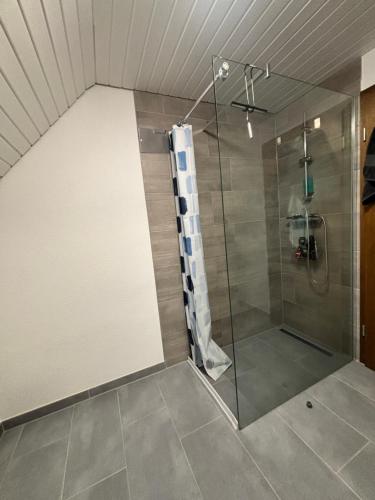 a bathroom with a shower with a glass door at Room4U in Memmingen