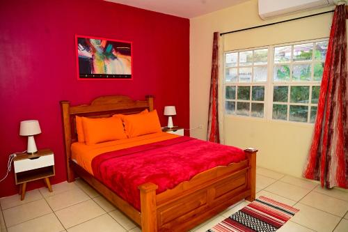 a red bedroom with a bed and a window at Cozy one bedroom & Car rental apartment in Lambeau