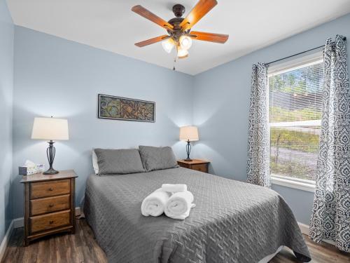 a bedroom with a bed with two towels at Jax Joint - Pet Friendly - Perfect Family Vacation Spot! in Crane Hill