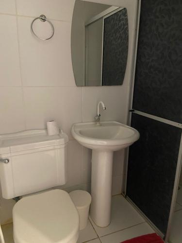 a bathroom with a sink and a toilet and a mirror at Luar Dos Milagres in São Miguel dos Milagres