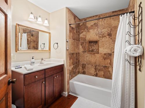 a bathroom with a tub and a sink and a shower at Carols Cottage - Double Decker Dock! Popular Location! in Cullman