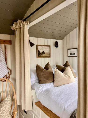 a bedroom with a bed in a room with at The Hut at Claston in Stoke Edith
