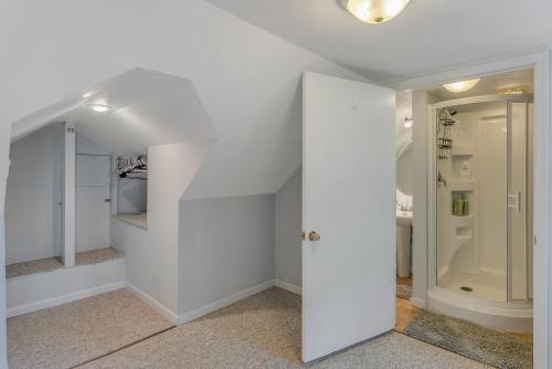 a hallway with white walls and an open door at Yellowhammer Hill - Amenities Galore! Near Cullman in Cullman