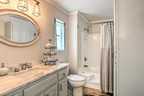 a bathroom with a sink and a toilet and a mirror at Cranes Nest - Huge Dock With Two Kayaks For The Guest's Use! in Crane Hill
