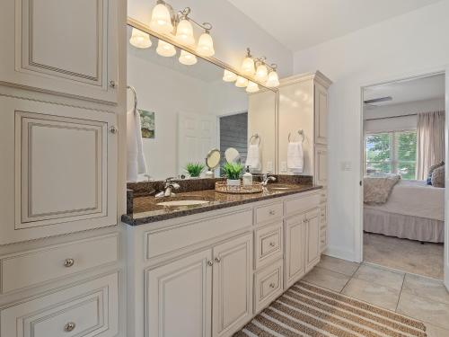 a bathroom with a sink and a large mirror at L & L Lodge - Six Bedrooms! Popular House And Location! in Double Springs
