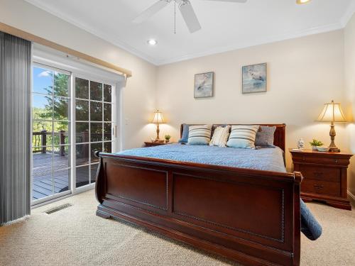 a bedroom with a bed and a sliding glass door at Blessings Family Lodge- Amazing Sunsets, Amazing Views! in Houston