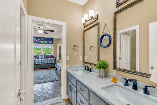a bathroom with two sinks and a large mirror at Lake Therapy - Gazebo On The Lake, Easy Walk To The Water! in Crane Hill