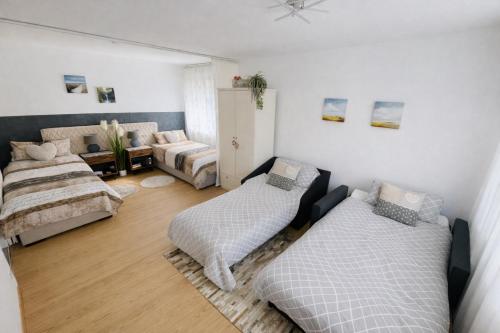 a living room with two beds and a couch at Apartment Messe Karlsruhe in Rheinstetten