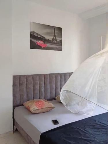 a bed in a room with a picture on the wall at Maryline house in Bizerte