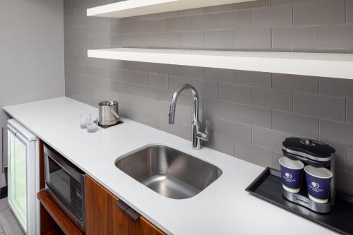 a kitchen with a sink and a microwave at DoubleTree by Hilton Hotel & Suites Pittsburgh Downtown in Pittsburgh