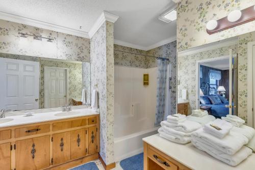 a bathroom with a sink and a tub and a mirror at Nanas Lakehouse - Private Dock With Jet-Ski Port! in Jasper