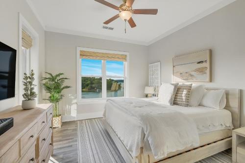 a white bedroom with a large bed and a window at Mallard Pointe Unit 200- Luxury Condo- Conveniently Located! in Cullman