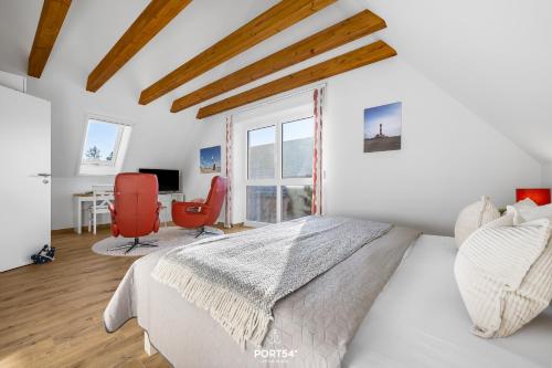 a bedroom with a bed and a table and chairs at Ferienhaus Ankerplatz St Peter-Ording in Böhl
