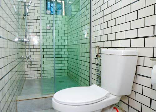 a bathroom with a toilet and a glass shower at Riverside Nest Owerri Ltd in Owerri
