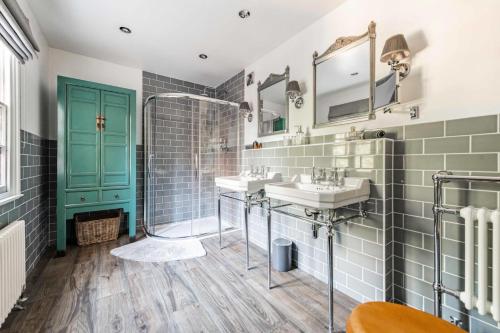 a bathroom with two sinks and a shower at Bressingham Lodge by Leap Escapes in Diss