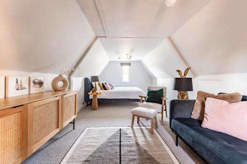 a living room with a couch and a bed at Bressingham Lodge by Leap Escapes in Diss