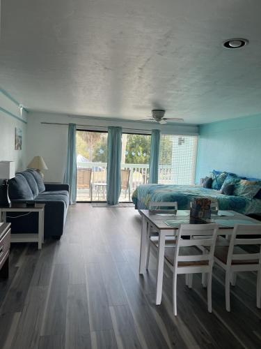 a bedroom with a bed and a table and chairs at Renovated Ocean-View Condo with Private Balcony in Cedar Key
