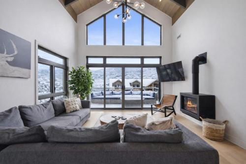 a living room with a large couch and a fireplace at Tremblant Prestige - Verbier 9-201 in Mont-Tremblant