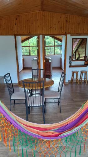 a hammock in a room with a table and chairs at Mindo Suites - Toucans in Quito