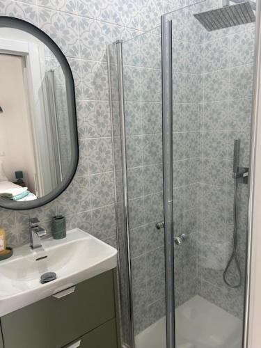 a bathroom with a shower and a sink and a mirror at The Ocean View Luz in Luz