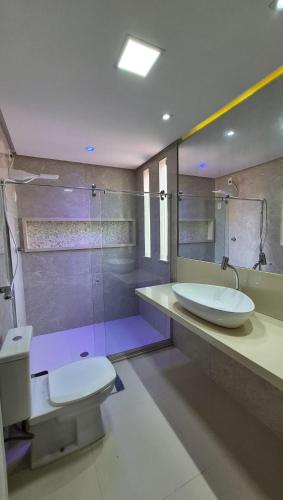 a bathroom with a toilet and a sink and a shower at Pitaia 3 in Aracaju