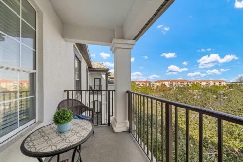 a balcony with a table and chairs and a view at Deluxe 3 Bedroom Apartment 404 in Orlando