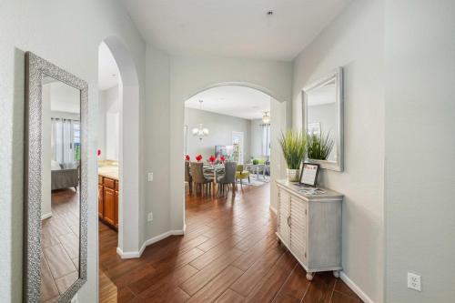 a living room and dining room with a mirror at Deluxe 3 Bedroom Apartment 404 in Orlando