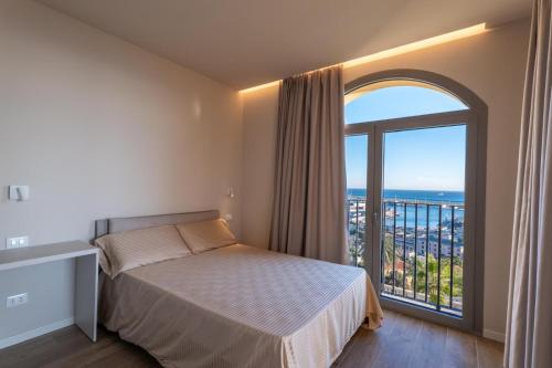 a bedroom with a bed and a large window at VillaPignone in Genoa