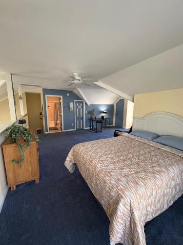 a bedroom with a large bed and blue carpet at Spacious Home Bethany Beach in Frankford