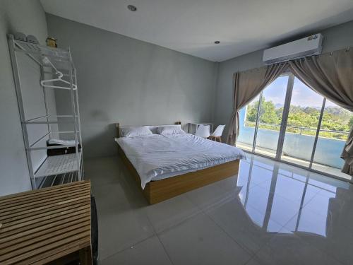 a bedroom with a bed with a ladder and a window at Safary Tour in Ban Ta Kun