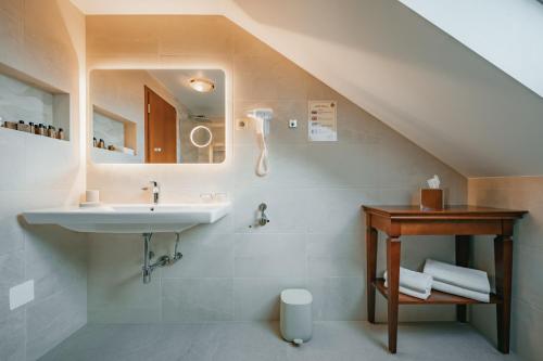 a bathroom with a sink and a mirror at Kala B&B in Kranjska Gora