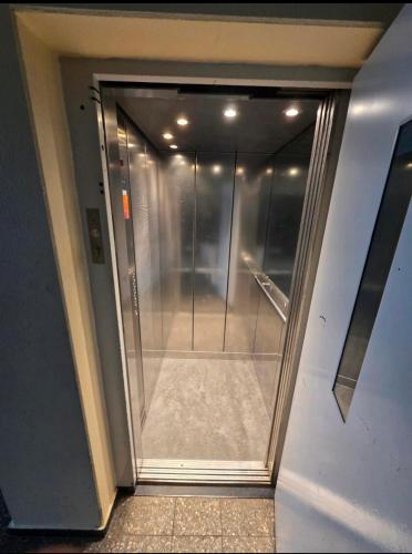 a glass door of a elevator in a building at Fewo GüNi Ostseeblick Wendtorf Marina Strand in Wendtorf