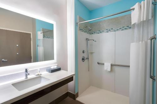 a bathroom with a sink and a shower at La Quinta by Wyndham Forsyth in Forsyth