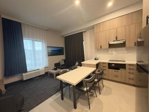 a kitchen and living room with a table and chairs at La Quinta Inn & Suites by Wyndham Kelowna BC in Kelowna
